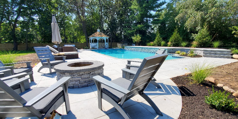 fire pit with porcelain pavers by the pool
